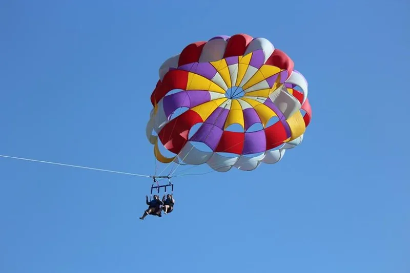 Tandem parasail flight high above turquoise water during parasailing in St. Thomas USVI off Sapphire Beach