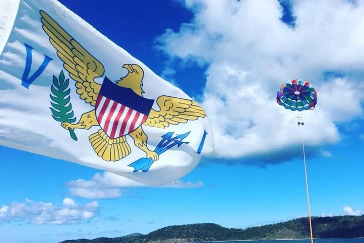 U.S. Virgin Islands flag flying above the boat with a parasail aloft during parasailing in St. Thomas USVI